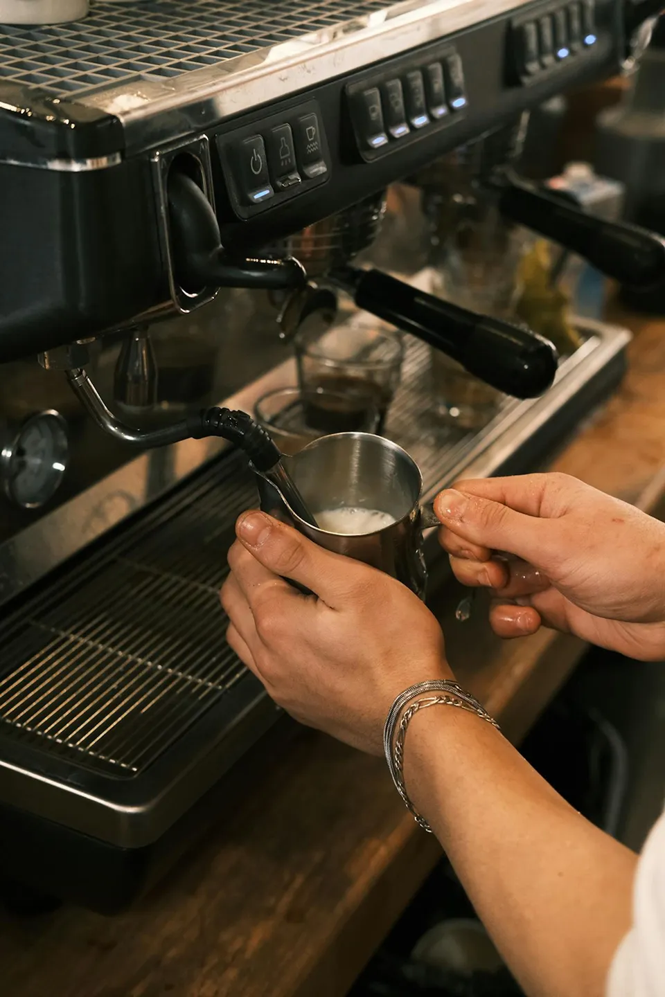 Barista crafting perfect milk foam in cafe